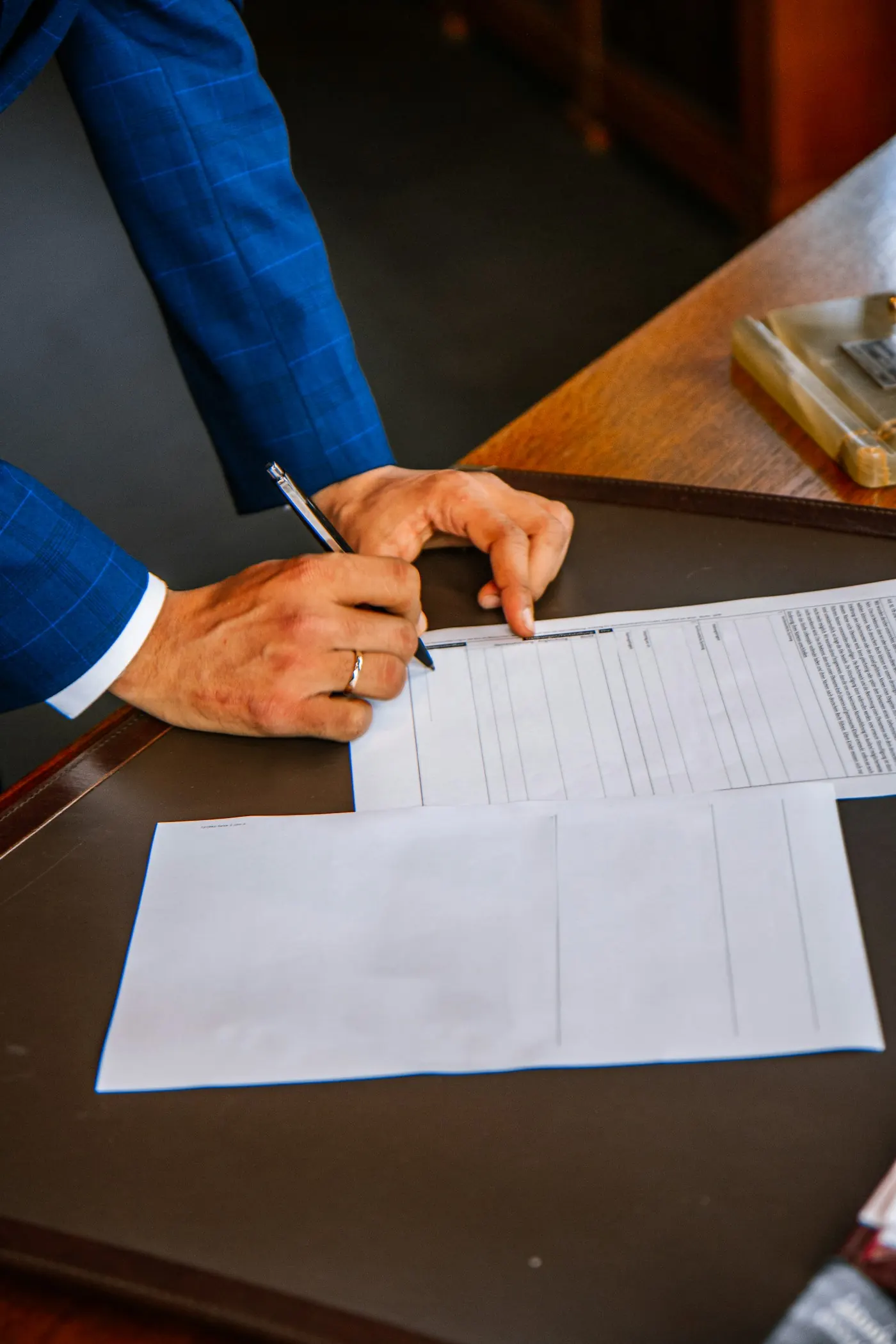 An advocate signing documents at a desk
